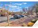 Community parking area with multiple parked pickup trucks and landscaping at 830 Cozette Ct # 102, Las Vegas, NV 89144