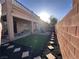 Wonderful backyard featuring artificial turf, stone pavers, and a fire pit area for outdoor enjoyment at 8651 Moreno Mountain Ave, Las Vegas, NV 89178