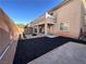 Spacious backyard with turf, patio, and fire pit offering a great outdoor living space at 8651 Moreno Mountain Ave, Las Vegas, NV 89178