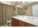 Neutral bathroom with a double sink vanity, stylish shower curtain and a large mirror at 8651 Moreno Mountain Ave, Las Vegas, NV 89178