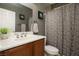 Standard bathroom featuring a single sink, tile flooring, and a shower with a decorative curtain at 8651 Moreno Mountain Ave, Las Vegas, NV 89178