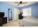 Bedroom with a blue wall and a black dresser with a ceiling fan above the bed covered with a comforter at 8651 Moreno Mountain Ave, Las Vegas, NV 89178