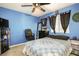 Bedroom with a blue wall and a black ceiling fan above a bed covered with a comforter at 8651 Moreno Mountain Ave, Las Vegas, NV 89178