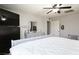 Bedroom with a gray wall and a black dresser with a ceiling fan above the bed covered with a comforter at 8651 Moreno Mountain Ave, Las Vegas, NV 89178