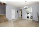 Bright living room with tile and carpet flooring, staircase, and contemporary decor at 8651 Moreno Mountain Ave, Las Vegas, NV 89178