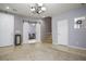Inviting living room with chandelier and staircase, blending tile and carpet flooring at 8651 Moreno Mountain Ave, Las Vegas, NV 89178