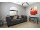 Comfortable living room with large gray sofa, neutral walls, and decorative wall art at 8651 Moreno Mountain Ave, Las Vegas, NV 89178