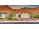 Single-story home with a modern design, two-car garage, and landscaped front yard at 89 Mirage View Dr, Henderson, NV 89011