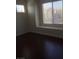Spacious bedroom with large window and dark hardwood floors at 8985 S Durango Dr # 2094, Las Vegas, NV 89113