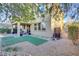 Covered patio, artificial turf, gravel landscaping, and a fenced area at 8992 Sparkling River Ct, Las Vegas, NV 89178