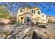 Two-story house with stone accents and a landscaped yard at 8992 Sparkling River Ct, Las Vegas, NV 89178