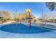 Play area with a soft surface, shade structures, and colorful play equipment at 8992 Sparkling River Ct, Las Vegas, NV 89178