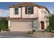Two-story house with brown roof, attached garage, and landscaping at 9156 Benton Woods St, Las Vegas, NV 89113