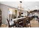 Open concept dining room and kitchen with large island and modern lighting at 9308 Noble Sage Ave, Las Vegas, NV 89148