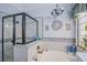 Bright bathroom boasts decorative tilework around the bathtub and shower at 10654 Sidlaw Hills Ct, Las Vegas, NV 89141
