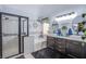 Stylishly renovated bathroom featuring a glass shower and dual sink vanity at 10654 Sidlaw Hills Ct, Las Vegas, NV 89141