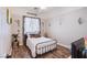 Bedroom featuring a full bed, stylish decor, and wood flooring at 10654 Sidlaw Hills Ct, Las Vegas, NV 89141
