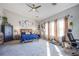 Spacious bedroom features large windows, neutral carpet, and a ceiling fan at 10654 Sidlaw Hills Ct, Las Vegas, NV 89141