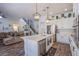 Open concept kitchen with island, stainless steel appliances, and wood flooring at 10654 Sidlaw Hills Ct, Las Vegas, NV 89141