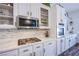 Modern kitchen features white cabinets, stainless steel appliances, and white marble countertops at 10654 Sidlaw Hills Ct, Las Vegas, NV 89141
