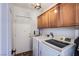 Laundry room equipped with washer, dryer, and overhead cabinets at 10654 Sidlaw Hills Ct, Las Vegas, NV 89141