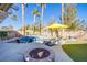 Beautiful pool and spa area with palm trees and a fire pit, creating a relaxing outdoor oasis at 10654 Sidlaw Hills Ct, Las Vegas, NV 89141