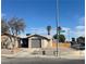 Single story house with grey garage door and desert landscaping at 11 Page St, Las Vegas, NV 89110