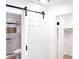 Bathroom with white sliding barn door and marble shower at 1470 Sutton Dr, Pahrump, NV 89048