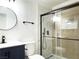 Modern bathroom with a walk-in shower, updated vanity, and neutral tile at 1470 Sutton Dr, Pahrump, NV 89048