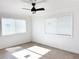 Bright bedroom with neutral decor, two windows with blinds, and tile floors at 1470 Sutton Dr, Pahrump, NV 89048