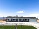 Newly constructed single-story home with gray exterior and a landscaped lawn at 1470 Sutton Dr, Pahrump, NV 89048