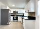 Modern kitchen featuring white cabinets, stainless steel appliances, and a breakfast bar at 1470 Sutton Dr, Pahrump, NV 89048