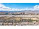 An aerial view of homes in a suburban neighborhood with snowy mountains as the backdrop at 1901 Shady Elm St, Las Vegas, NV 89135