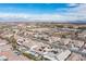 Las Vegas neighborhood aerial view featuring tile roofs, swimming pools, desert landscaping, and solar panels on the roofs at 1901 Shady Elm St, Las Vegas, NV 89135