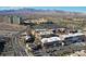 Aerial view of a shopping center surrounded by commercial buildings, golf course, and residential towers in Nevada at 1901 Shady Elm St, Las Vegas, NV 89135