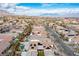Birds eye view of a neighborhood with manicured lawns, desert landscaping, and swimming pools in Las Vegas, Nevada at 1901 Shady Elm St, Las Vegas, NV 89135