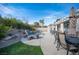This home features a backyard pool, lounge chair, patio set, and well manicured landscaping at 1901 Shady Elm St, Las Vegas, NV 89135