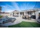 This home features a backyard pool, lounge chair, outdoor seating, green grass, and a grill at 1901 Shady Elm St, Las Vegas, NV 89135