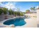 This home features a lovely swimming pool, mature trees, shrubs, and a basketball hoop at 1901 Shady Elm St, Las Vegas, NV 89135