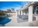 This home features a backyard pool, stone pool border, and a covered outdoor seating area at 1901 Shady Elm St, Las Vegas, NV 89135
