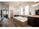 Bright bathroom featuring a soaking tub, dual vanities, wood-look flooring and modern fixtures at 1901 Shady Elm St, Las Vegas, NV 89135