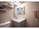 Bathroom vanity with marble countertop, stylish fixtures, mirror, and neutral paint at 1901 Shady Elm St, Las Vegas, NV 89135