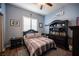 Cozy bedroom with a plaid bedspread, laminate floors and a dark wood dresser at 1901 Shady Elm St, Las Vegas, NV 89135