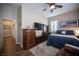 Cozy bedroom features wood-look floors, a ceiling fan, and a comfortable blue bedspread at 1901 Shady Elm St, Las Vegas, NV 89135