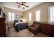 Comfortable bedroom with a ceiling fan, wood-look flooring, and cozy recliner at 1901 Shady Elm St, Las Vegas, NV 89135