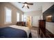 This charming bedroom features a ceiling fan, wood-look flooring, and a blue bedspread at 1901 Shady Elm St, Las Vegas, NV 89135