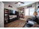 Comfortable bedroom featuring a ceiling fan, TV, a pair of leather reclining chairs, and laminate floors at 1901 Shady Elm St, Las Vegas, NV 89135