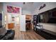 Comfortable bedroom featuring a ceiling fan, TV, a pair of leather reclining chairs, and laminate floors at 1901 Shady Elm St, Las Vegas, NV 89135