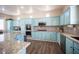 Beautiful kitchen with light blue cabinets, stainless steel appliances, and granite countertops at 1901 Shady Elm St, Las Vegas, NV 89135