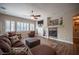 Cozy living room featuring a fireplace, large windows, and comfortable seating arrangement at 1901 Shady Elm St, Las Vegas, NV 89135